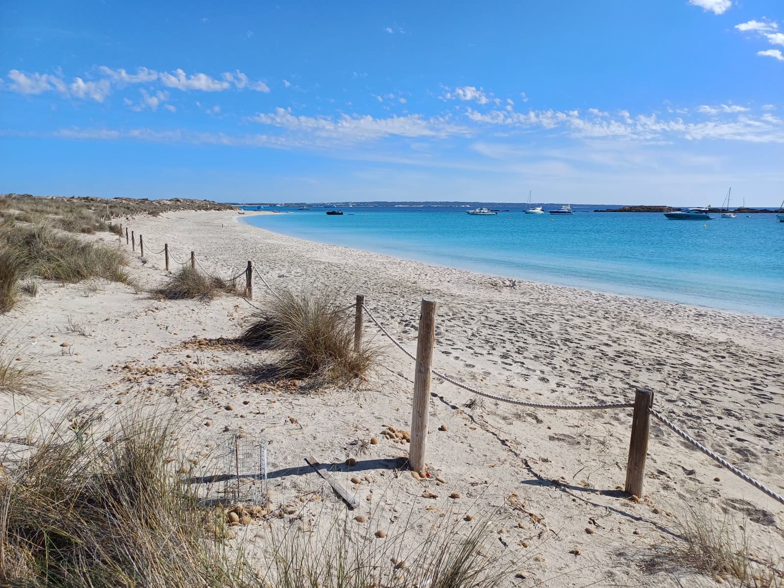 Quiet Formentera beach with boats anchored offshore