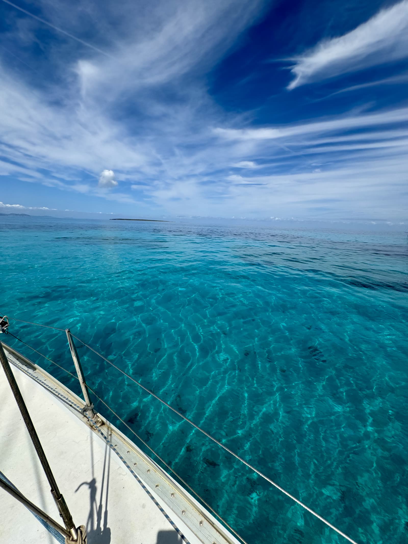 Turquoise water seen from the deck of a sailboat